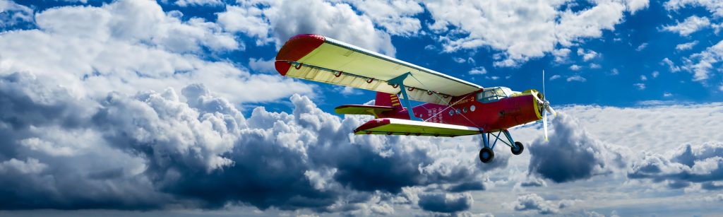 biplane over clouds red fly aircraft